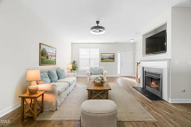 a living room with furniture a fireplace and a flat screen tv