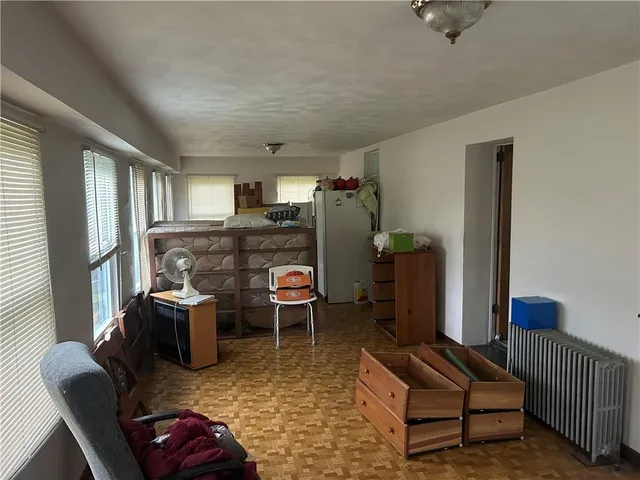 a living room with furniture rug and wooden floor