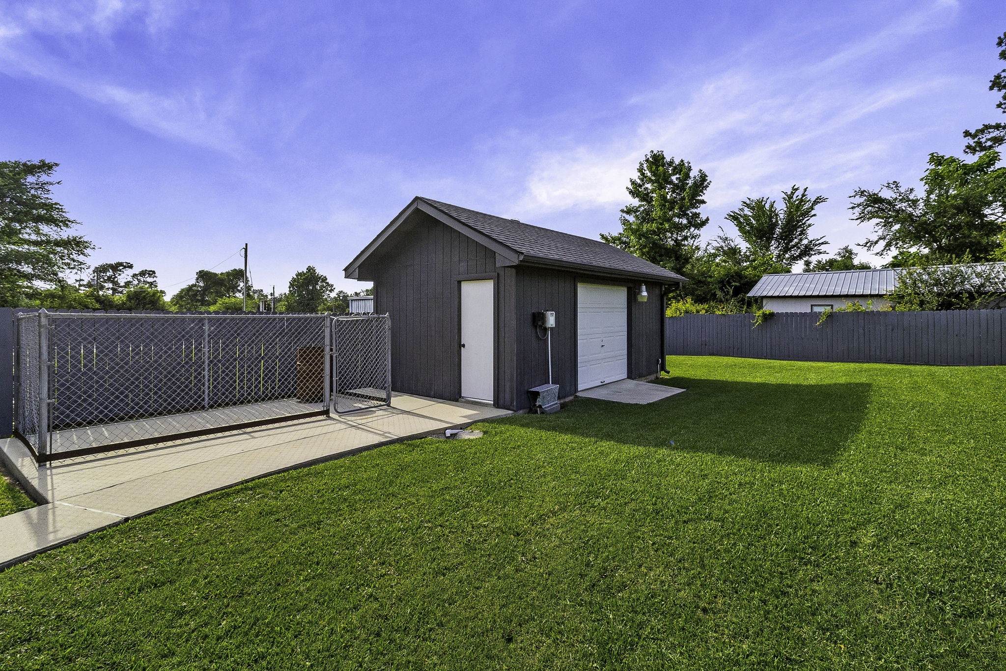 188 Huckleberry Road Onalaska, TX 77360 - Photo 36 of 49 a view of a house with a yard and a large tree