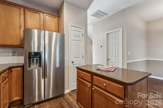 a kitchen with stainless steel appliances granite countertop a sink stove microwave and refrigerator
