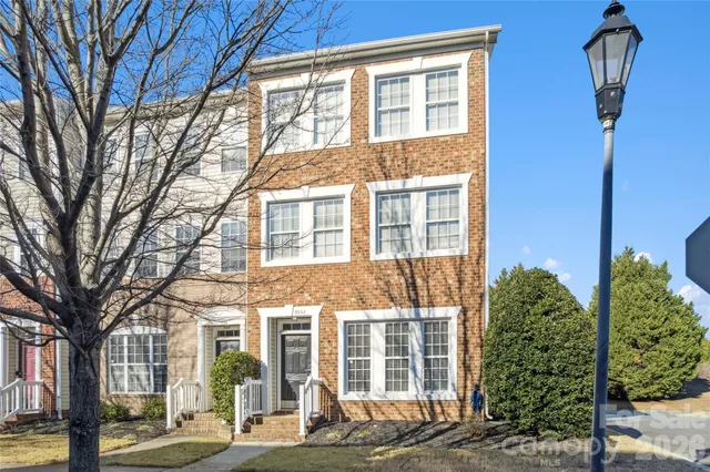 a view of a brick building next to a yard