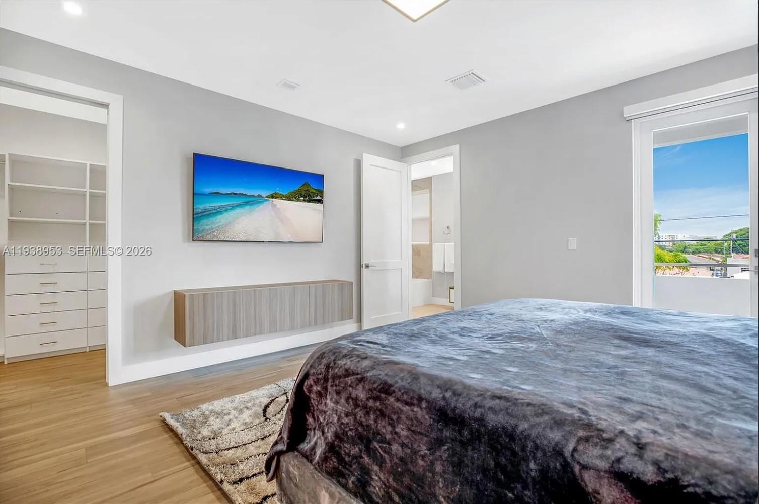 3655 Southwest 26th Street Miami, FL 33133 - Photo 12 of 15 a bedroom with a bed and a painting on the wall