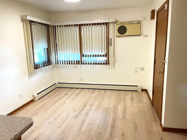 a view of a room with wooden floor and windows