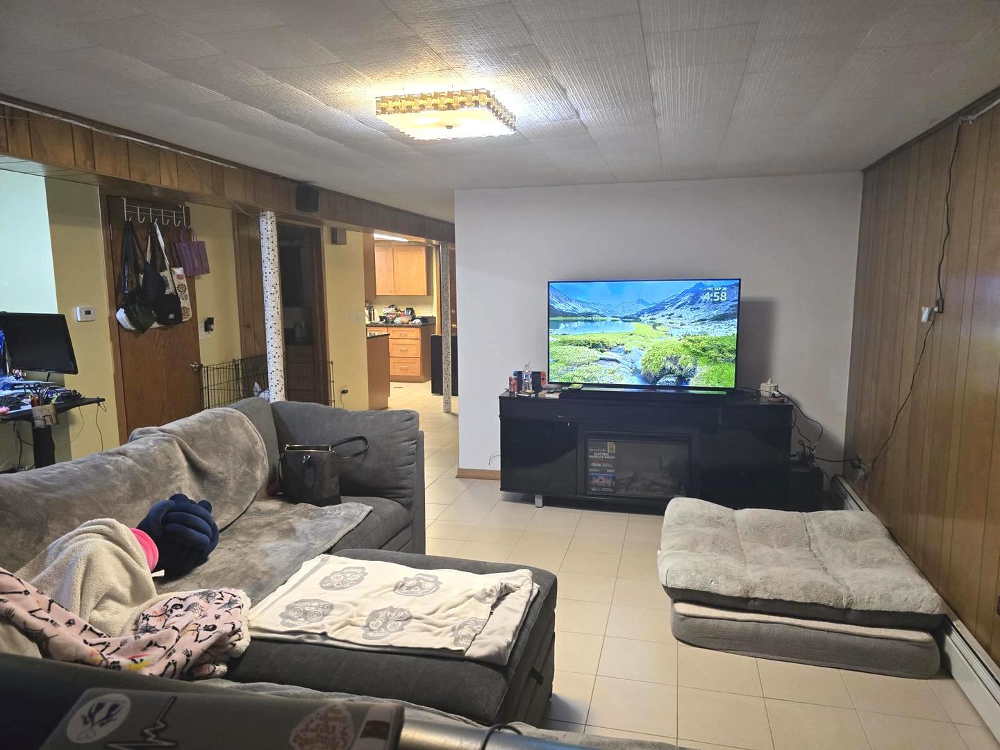 6614 West Devon Avenue Chicago, IL 60631 - Photo 13 of 21 a living room with furniture and a flat screen tv