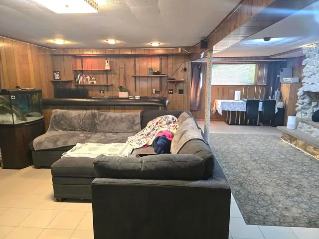 a living room with furniture and a view of kitchen