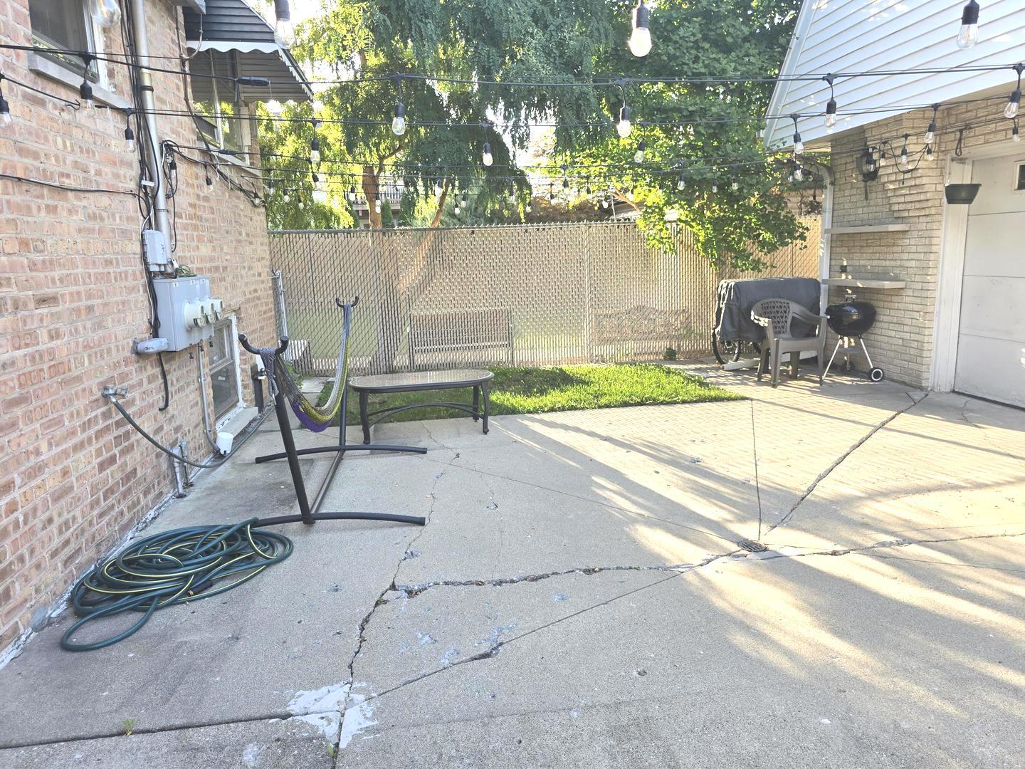 6614 West Devon Avenue Chicago, IL 60631 - Photo 19 of 21 a view of backyard with a table and chairs