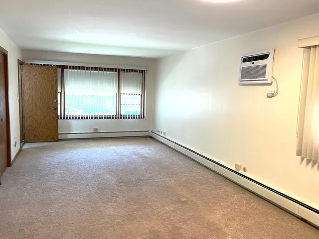 an empty room with a empty space and windows