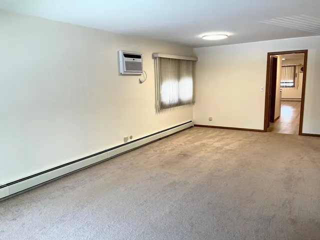 an empty room with windows and closet