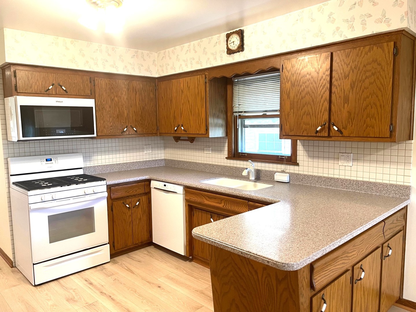 6614 West Devon Avenue Chicago, IL 60631 - Photo 6 of 21 a kitchen with stainless steel appliances granite countertop a sink stove and microwave