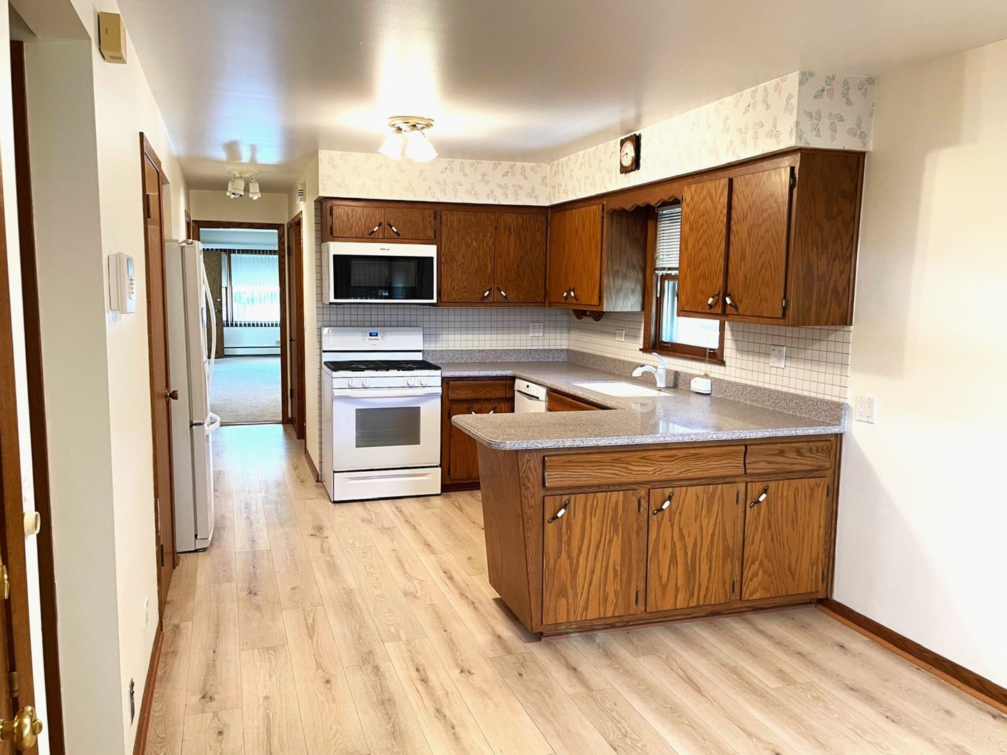 6614 West Devon Avenue Chicago, IL 60631 - Photo 7 of 21 a kitchen with stainless steel appliances granite countertop a sink a stove and a refrigerator