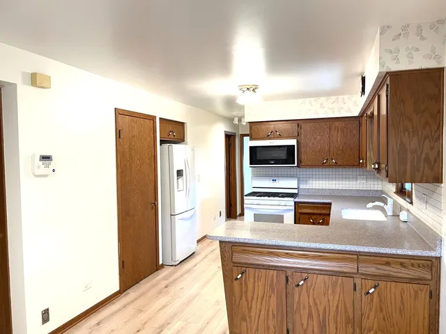 a kitchen with stainless steel appliances a refrigerator and a stove