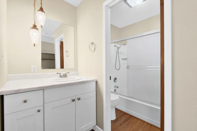 a green field with lots of trees in the background