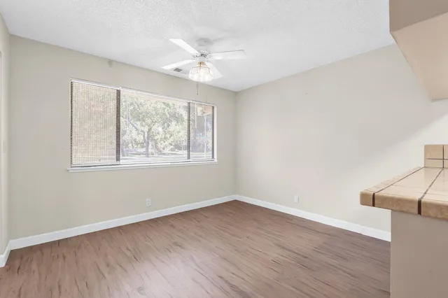a kitchen with white cabinets stainless steel appliances and sink