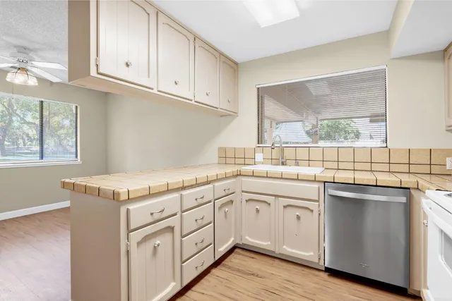 a view of staircase with wooden floor and white walls