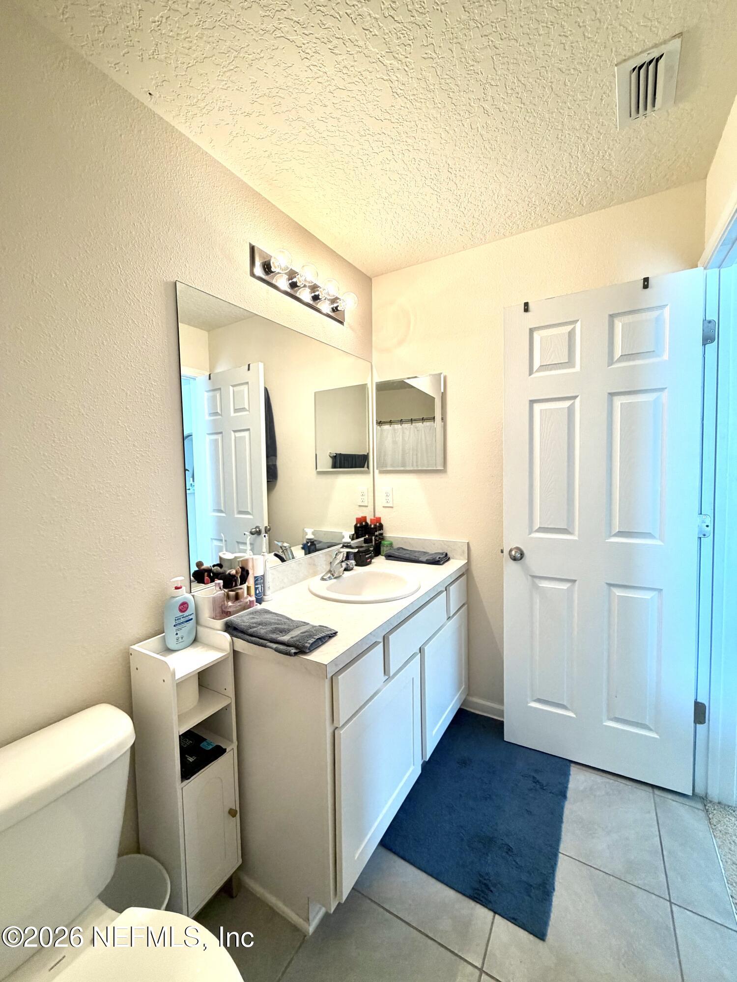 845 Observatory Parkway Jacksonville, FL 32218 - Photo 23 of 42 a bathroom with a sink toilet vanity and shower