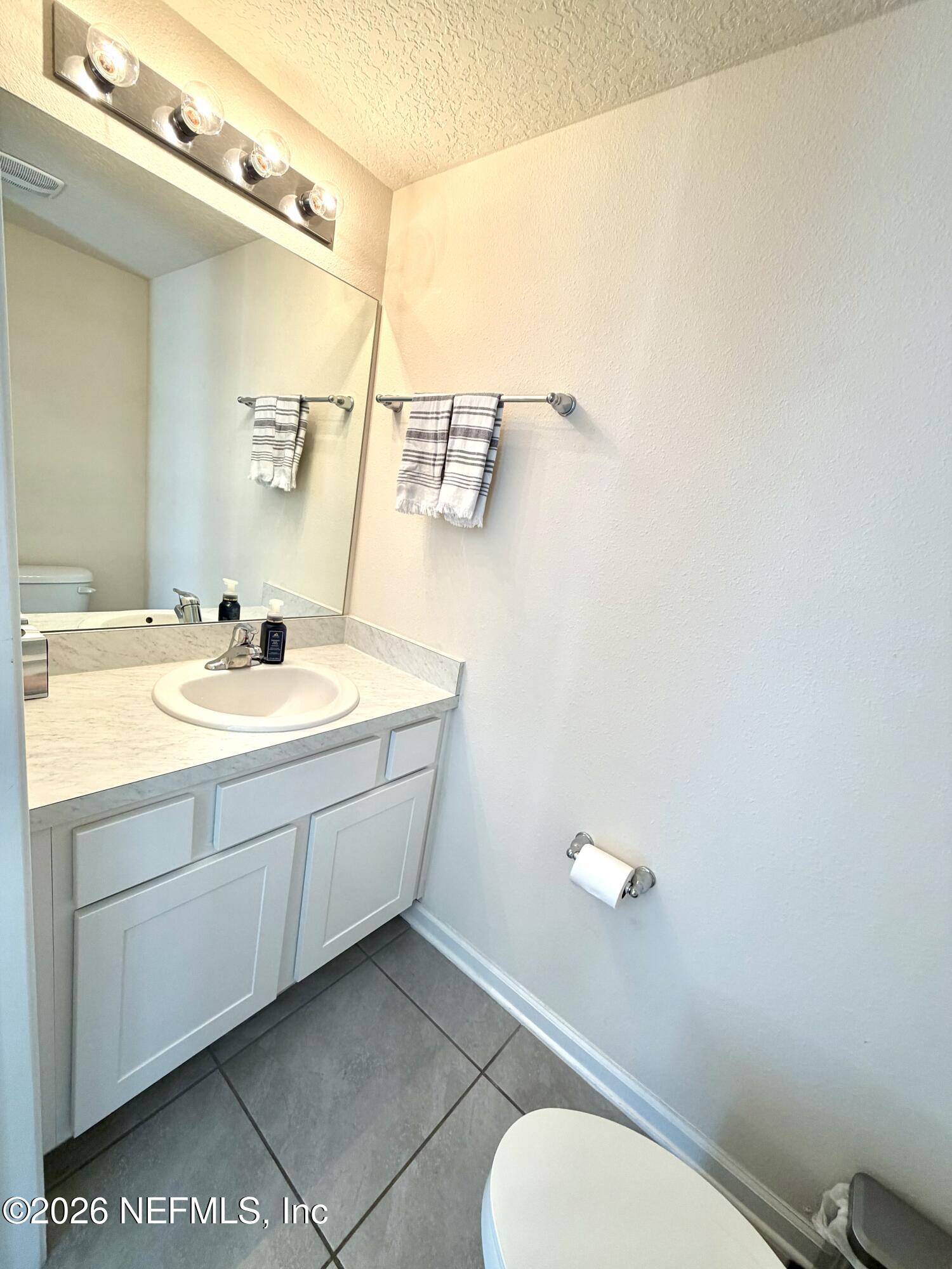845 Observatory Parkway Jacksonville, FL 32218 - Photo 32 of 42 a bathroom with a double vanity sink mirror and toilet