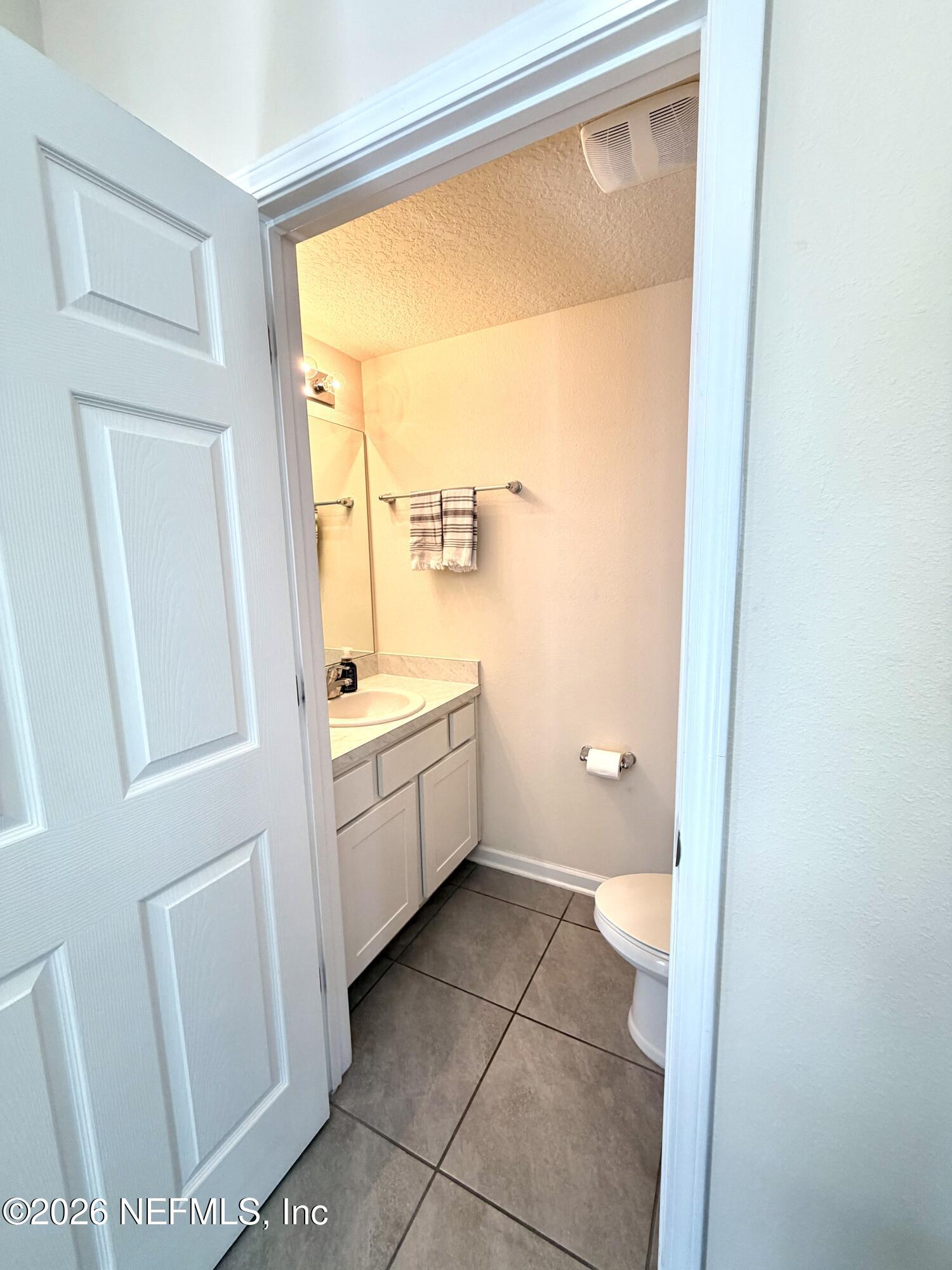 845 Observatory Parkway Jacksonville, FL 32218 - Photo 33 of 42 a bathroom with a granite countertop sink a mirror and a toilet
