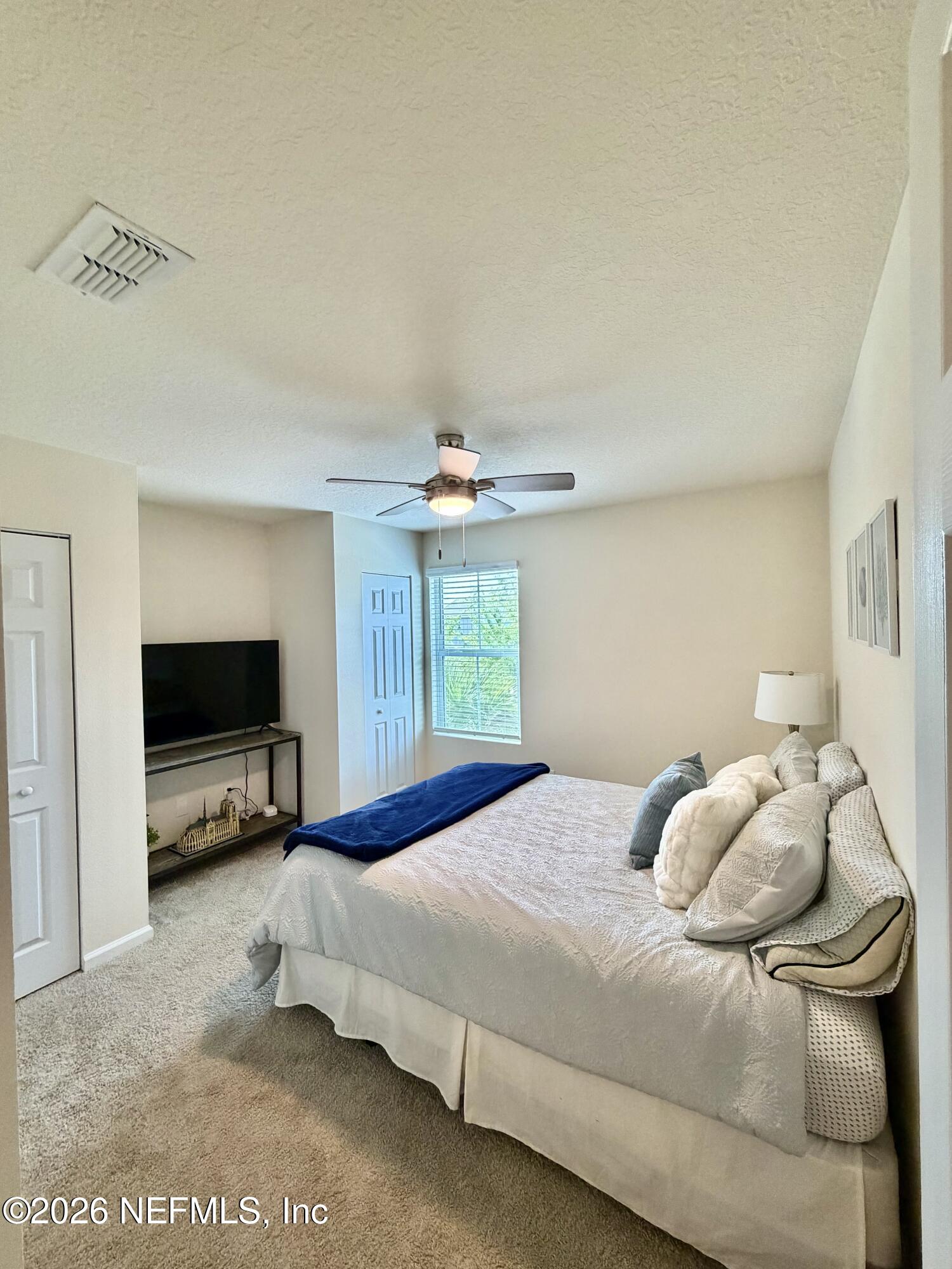 845 Observatory Parkway Jacksonville, FL 32218 - Photo 6 of 42 a bedroom with a bed and a flat tv screen on dresser