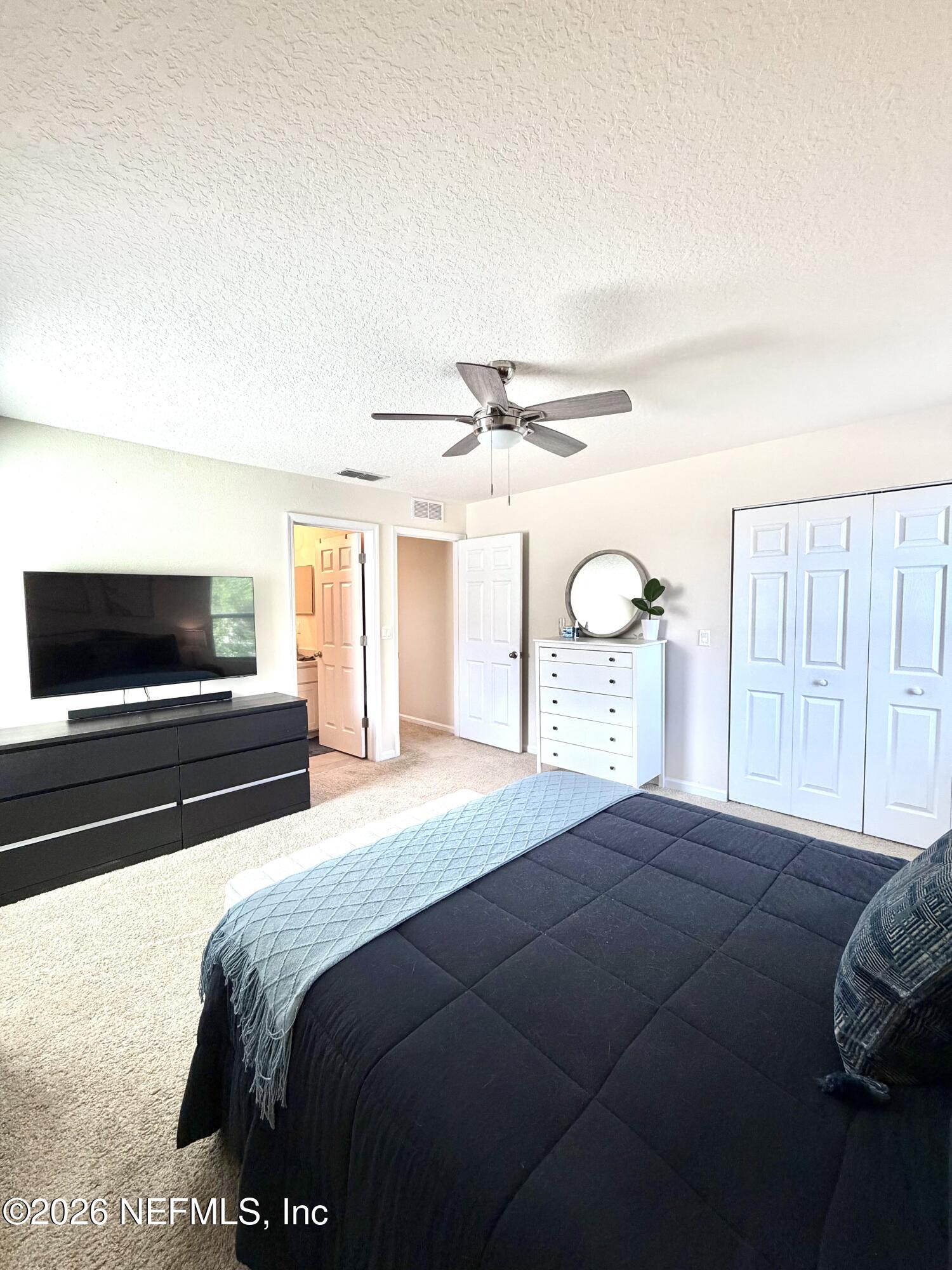 845 Observatory Parkway Jacksonville, FL 32218 - Photo 7 of 42 a bedroom with a large bed and a tv