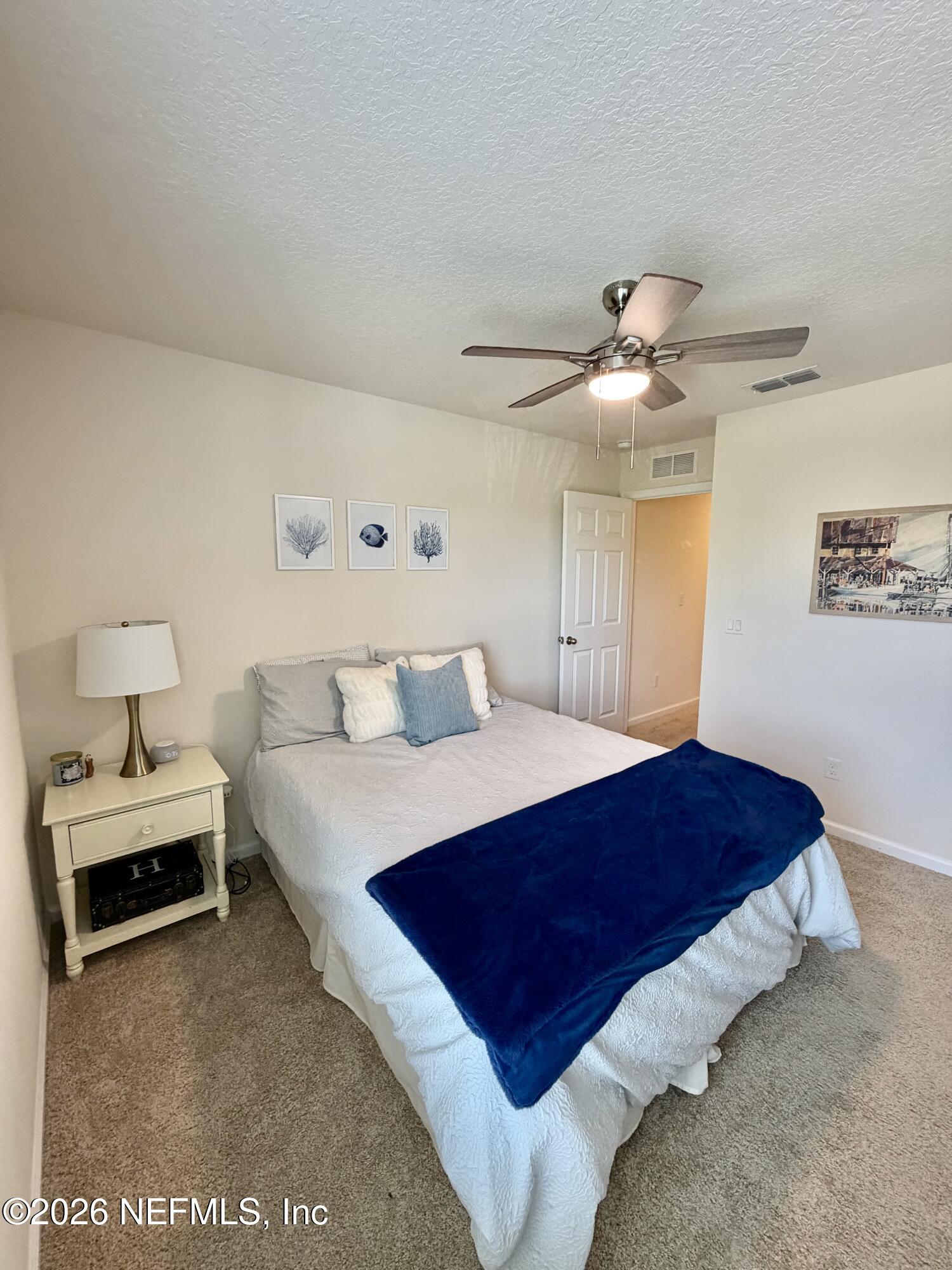 845 Observatory Parkway Jacksonville, FL 32218 - Photo 8 of 42 a bedroom with a bed and a chandelier