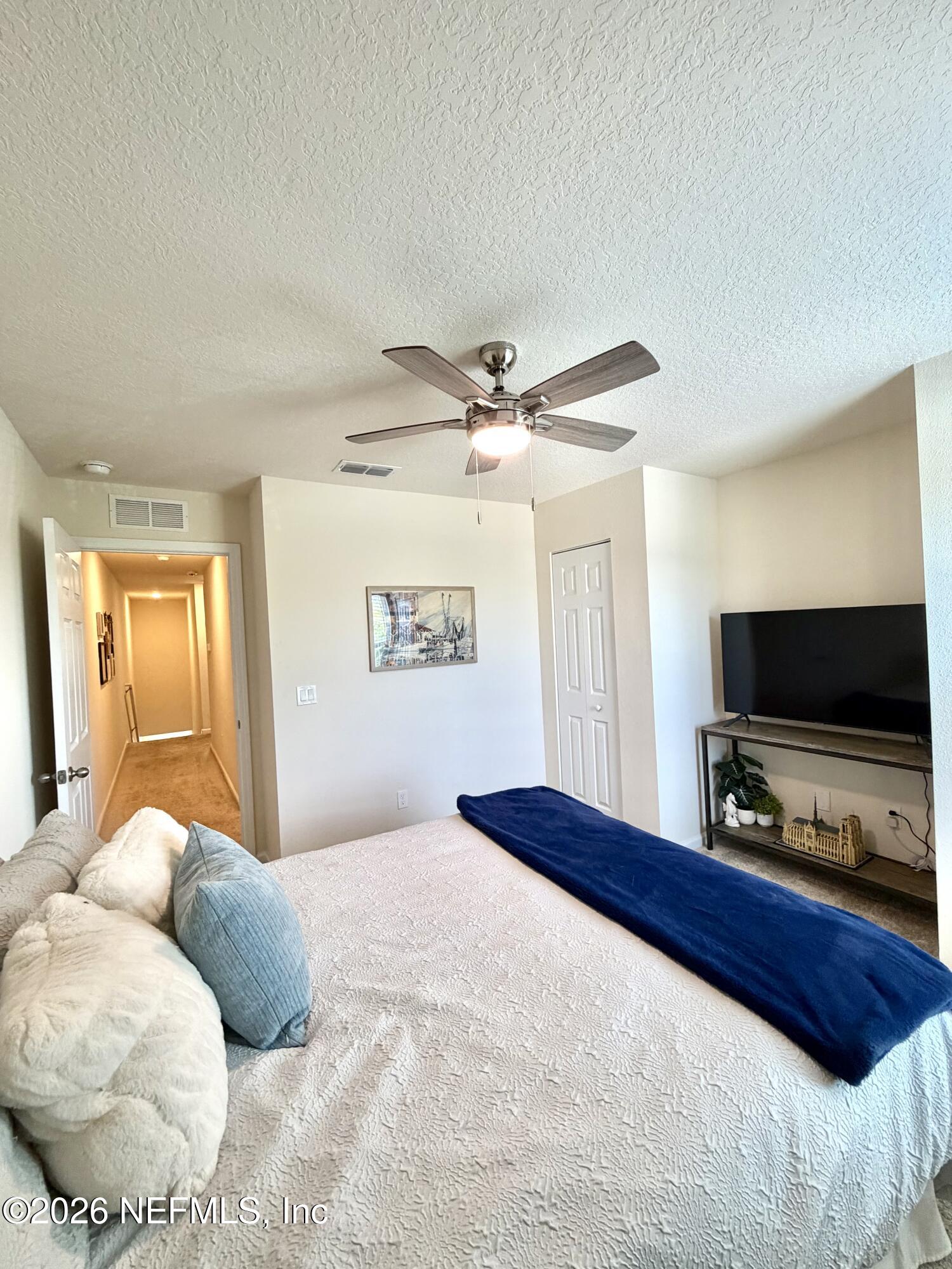 845 Observatory Parkway Jacksonville, FL 32218 - Photo 9 of 42 a bedroom with a bed and a flat screen tv