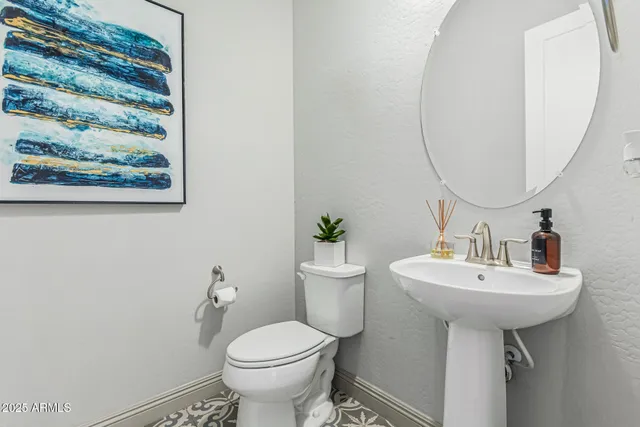 a bathroom with a sink toilet and a mirror