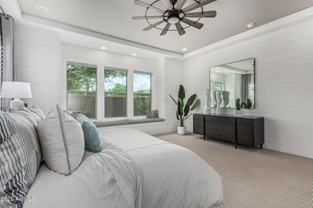 a bedroom with a large bed and a chandelier