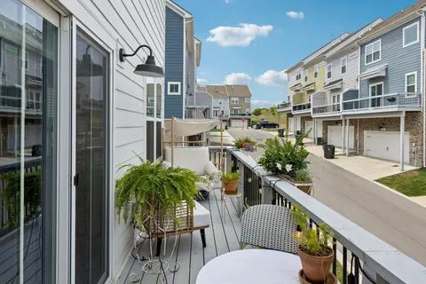 a balcony with table and chairs