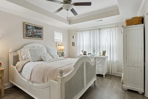 a bedroom with a bed and a chandelier
