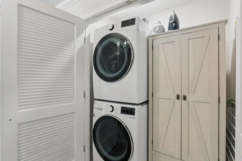 a view of a hallway with washer and dryer