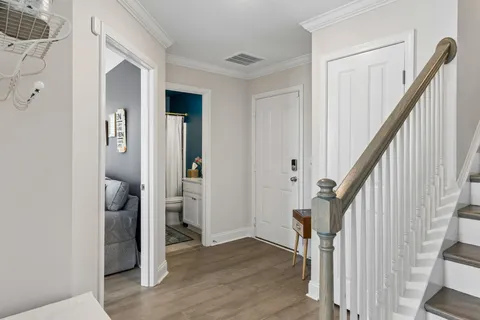 a view of entryway and hall with wooden floor