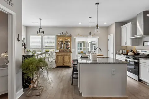 a kitchen with counter top space cabinets and wooden floor