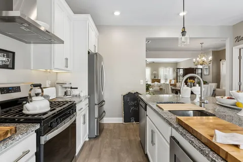 a kitchen with a sink stove and refrigerator