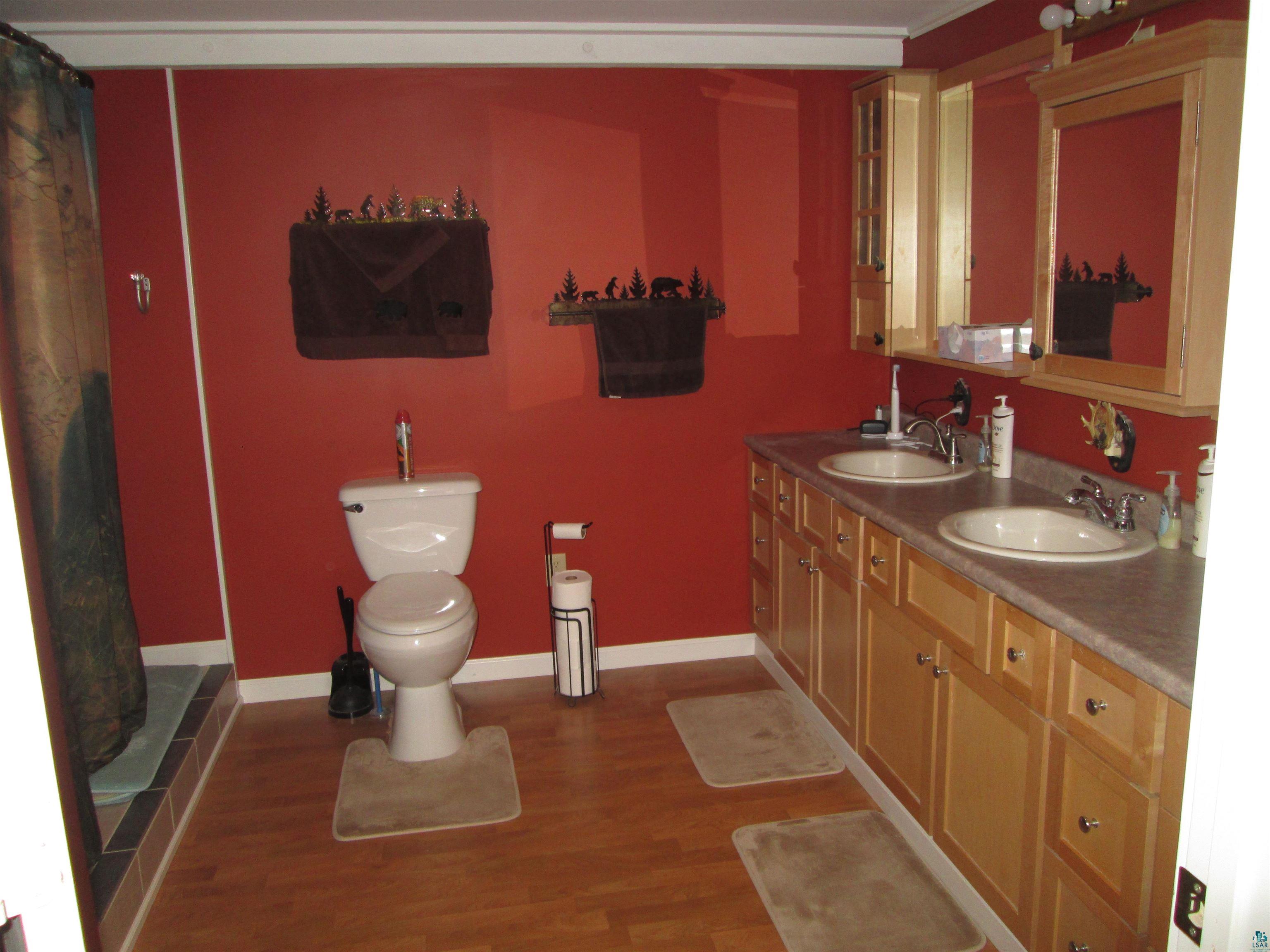 8882 Shortcut Road Lake Nebagamon, WI 54849 - Photo 19 of 47 Full bathroom with toilet, wood finished floors, and a sink