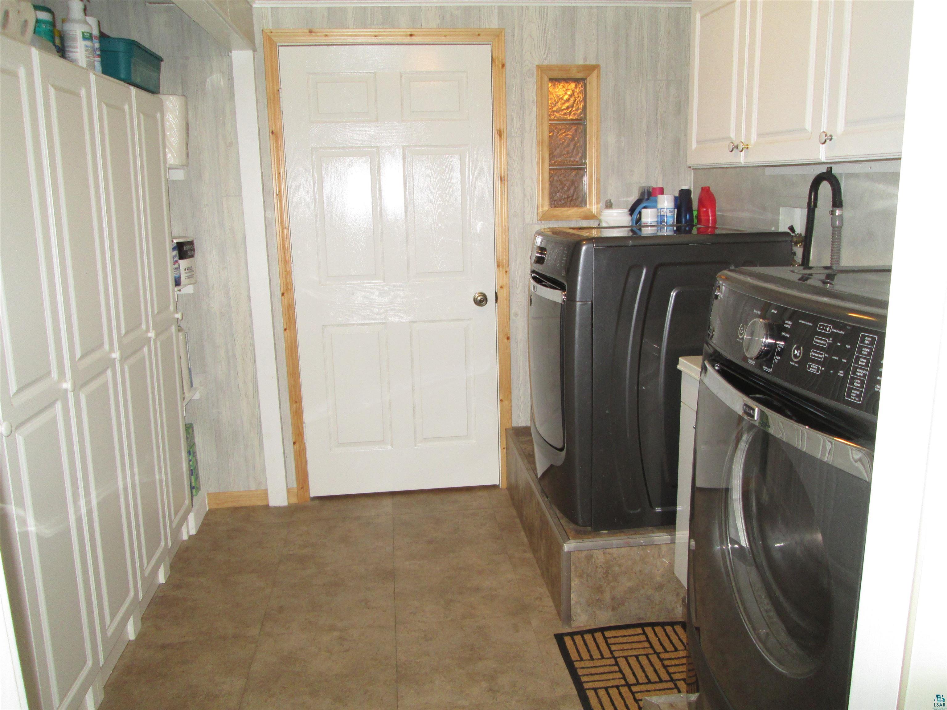 8882 Shortcut Road Lake Nebagamon, WI 54849 - Photo 21 of 47 Laundry room featuring washing machine and dryer and cabinet space