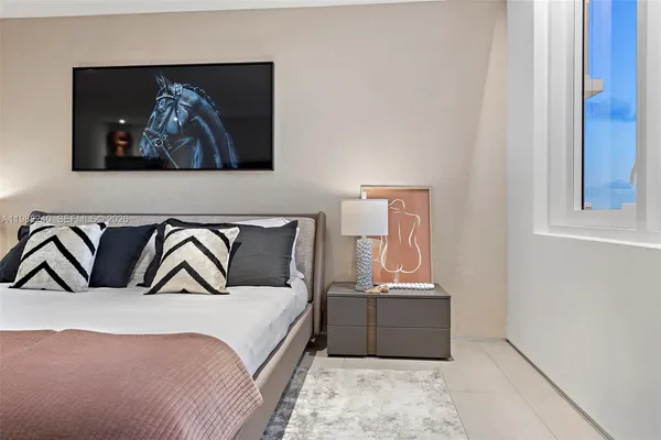 a bedroom with a bed and a wall painting