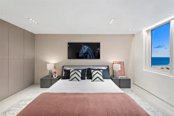 a bedroom with a bed and a chair