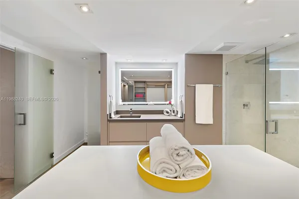 a bathroom with a tub sink and mirror