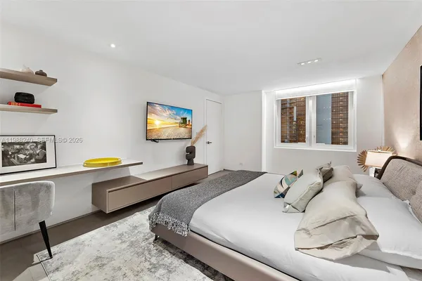 a bedroom with a bed and a dresser