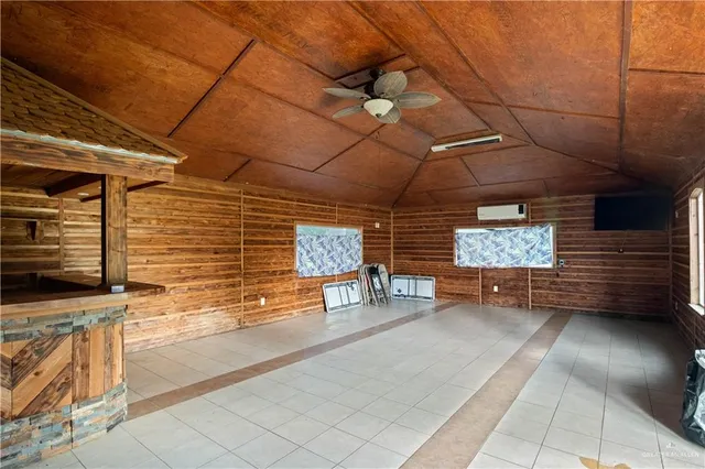 a view of a garage with wooden table and chairs