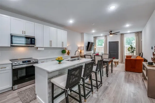 a kitchen with a table chairs stove and microwave