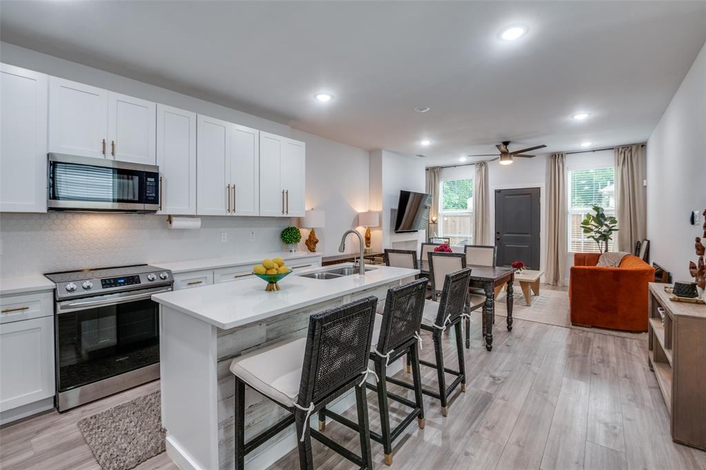 2325 Budd Street Dallas, TX 75215 - Photo 2 of 12 a kitchen with a table chairs stove and microwave