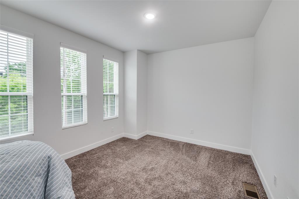 2325 Budd Street Dallas, TX 75215 - Photo 7 of 12 a bedroom with a bed and a window