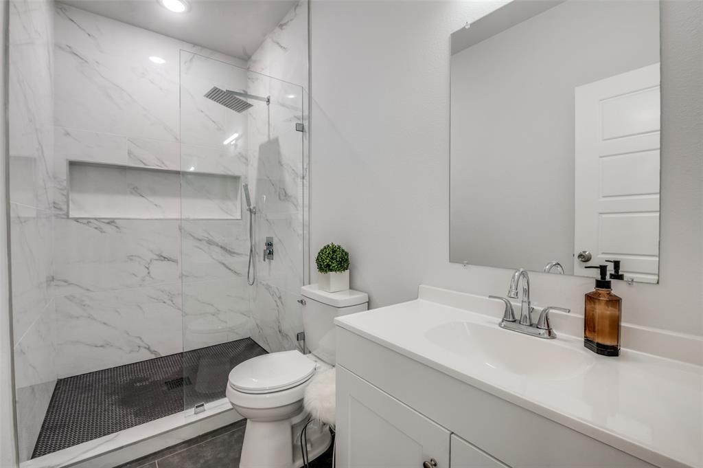 2325 Budd Street Dallas, TX 75215 - Photo 8 of 12 a bathroom with a sink a toilet and shower