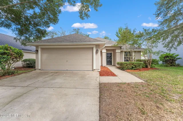 a view of house with outdoor space and trees