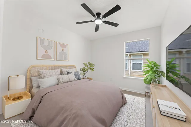 a bedroom with a bed and a potted plant