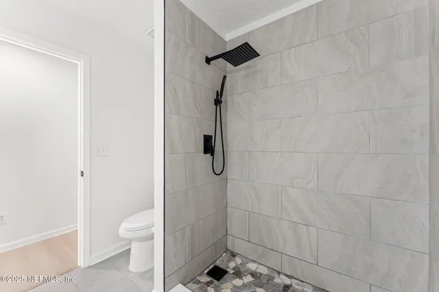 a bathroom with a toilet and a shower