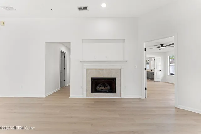 a living room with a fireplace and a wooden floor