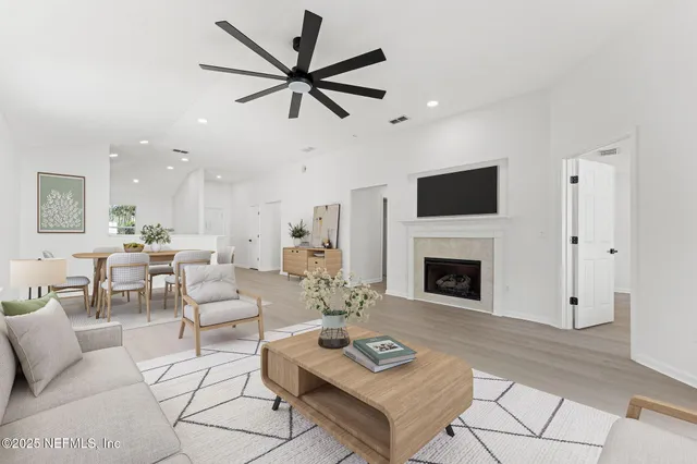 a living room with furniture a fireplace and a flat screen tv
