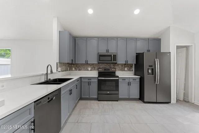 a kitchen with a sink stove and refrigerator
